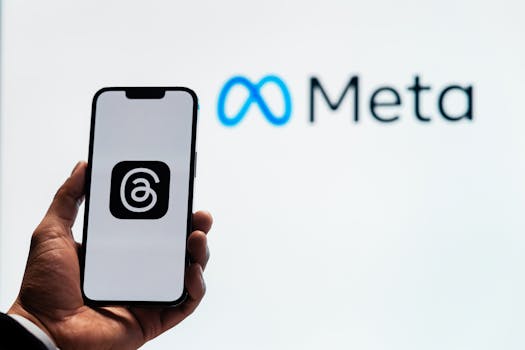 Cómo pagar ads de Facebook en Colombia 16 A hand holding a smartphone showing the Threads app with Meta logo in the background.